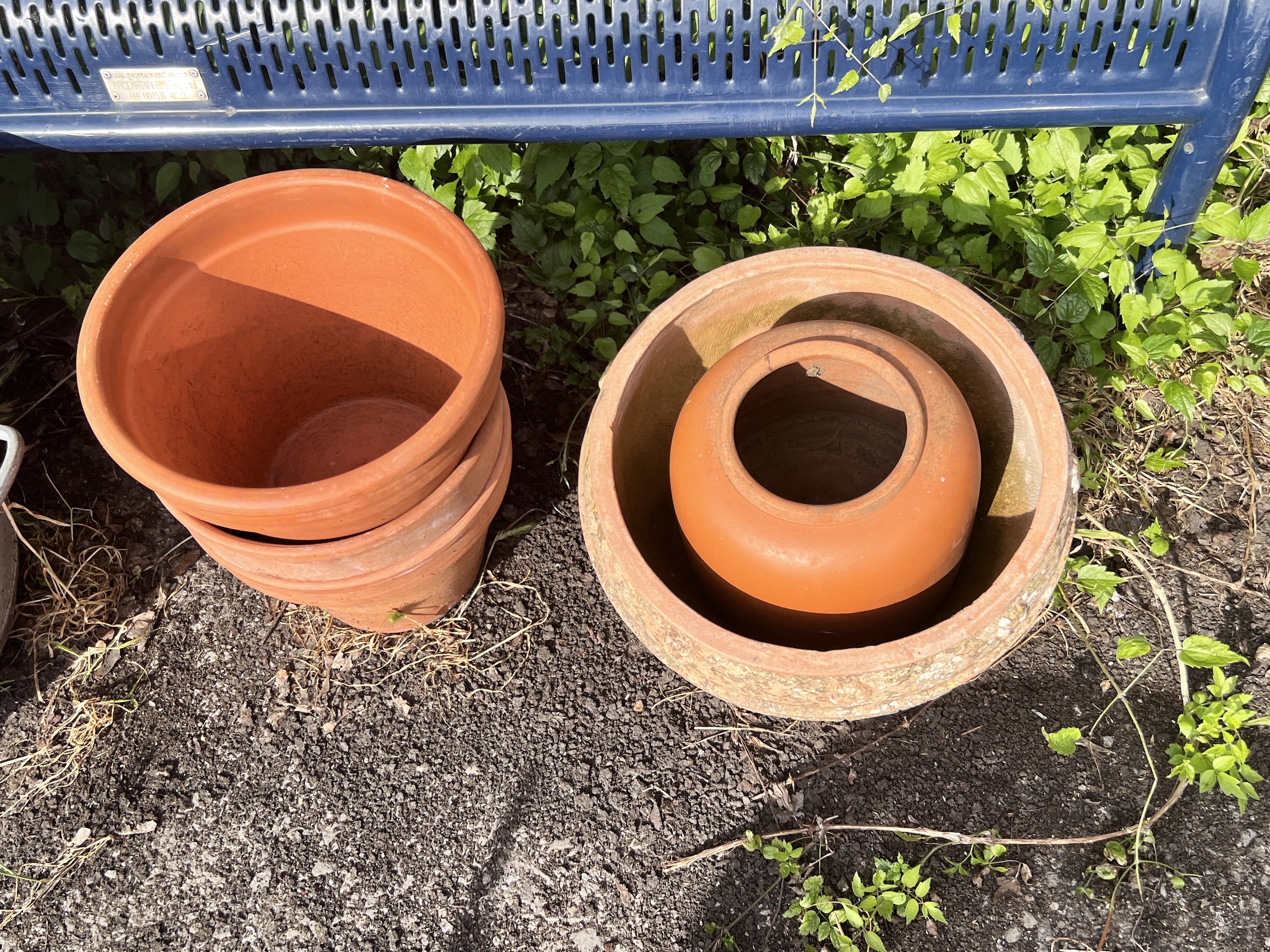 A large circular galvanised tub, diameter 72cm, together with a quantity of assorted terracotta garden pots